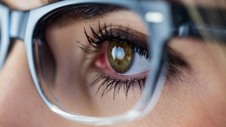 close up of woman's eye and glasses