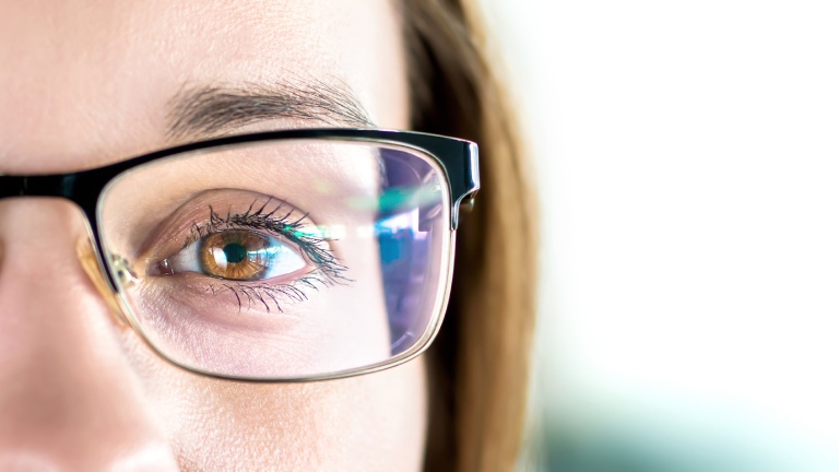 close up of woman's eye and glasses