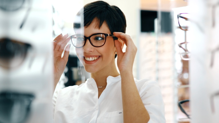 woman trying on glasses frames